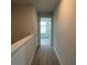 Well-lit hallway with neutral walls and carpet flooring, connecting various rooms at 134 Lilac Grove Way, Summerville, SC 29486