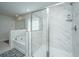Modern bathroom featuring a glass enclosed shower with marble tile surround and a soaking tub at 143 Oyster Tide Ave, Summerville, SC 29485
