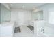 Spacious bathroom featuring a soaking tub with marble tile and double sink vanity with large mirrors at 143 Oyster Tide Ave, Summerville, SC 29485