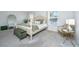 Serene bedroom with four poster bed, soft lighting, and tranquil green and white color scheme at 143 Oyster Tide Ave, Summerville, SC 29485