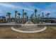 A vibrant community park features a brick gathering area and palm-lined walkway, enhancing the neighborhood's charm and appeal at 143 Oyster Tide Ave, Summerville, SC 29485