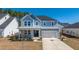 Beautiful two-story home featuring a covered porch, attached garage, and spacious driveway at 143 Oyster Tide Ave, Summerville, SC 29485