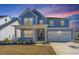 Charming two-story home showcasing a well-manicured front yard and an inviting covered porch at 143 Oyster Tide Ave, Summerville, SC 29485
