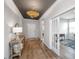 Welcoming foyer with wood-look floors, decorative light fixture and a console table at 143 Oyster Tide Ave, Summerville, SC 29485