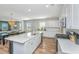 Bright kitchen with island, stainless steel appliances, and adjacent dining and living areas at 143 Oyster Tide Ave, Summerville, SC 29485