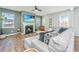 Cozy living room with a fireplace, large windows, and comfortable seating area at 143 Oyster Tide Ave, Summerville, SC 29485