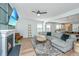 Bright living room with fireplace, ceiling fan, stylish decor, and an open floor plan at 143 Oyster Tide Ave, Summerville, SC 29485