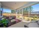 Inviting screened-in porch features comfortable seating, neutral decor, and outdoor views, perfect for relaxing and entertaining at 143 Oyster Tide Ave, Summerville, SC 29485