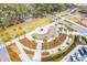 Aerial view of an expertly designed public space featuring manicured lawns, a water feature, and walking paths at 145 Pier View St # 316, Charleston, SC 29492