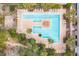 Aerial view of a large community pool surrounded by tropical landscaping and plenty of lounge seating at 145 Pier View St # 316, Charleston, SC 29492