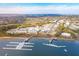 Stunning aerial view of a waterfront community featuring a marina, upscale buildings, and picturesque coastal scenery at 145 Pier View St # 316, Charleston, SC 29492