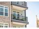 Close-up of a balcony with wrought iron railing, showing potted plants and outdoor furniture at 145 Pier View St # 316, Charleston, SC 29492