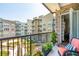 Charming balcony view adorned with colorful flowers and overlooking a lush green space and neighboring buildings at 145 Pier View St # 316, Charleston, SC 29492