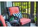 Close-up of inviting balcony seating with coral cushions, striped pillows and a side table with succulents at 145 Pier View St # 316, Charleston, SC 29492