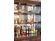 Sophisticated bar area with mirrored shelving, showcasing glassware and an extensive collection of beverages at 145 Pier View St # 316, Charleston, SC 29492