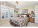 Inviting bedroom with a plaid bedspread, bedside tables, and large windows with natural light at 145 Pier View St # 316, Charleston, SC 29492