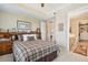 Comfortable bedroom featuring a plaid bedspread and elegant décor, leading to an ensuite bathroom at 145 Pier View St # 316, Charleston, SC 29492