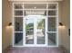 Elegant glass entrance doors to 145 Pier View, showing reflection of the outside and a well-maintained interior at 145 Pier View St # 316, Charleston, SC 29492
