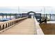 Picturesque wooden dock leading to a marina with boats, offering access to waterfront adventures at 145 Pier View St # 316, Charleston, SC 29492