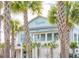 Charming coastal-style building, The Kingstide, framed by lush palm trees at 145 Pier View St # 316, Charleston, SC 29492