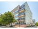 Multi-story apartment building with brick and siding, featuring balconies, a well-maintained lawn, and greenery at 145 Pier View St # 316, Charleston, SC 29492