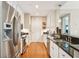 Well-lit kitchen features stainless steel appliances, granite countertops, mosaic backsplash, and hardwood flooring at 145 Pier View St # 316, Charleston, SC 29492