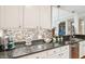 Bright kitchen featuring granite countertops, a mosaic backsplash, stainless steel appliances, and a coffee station at 145 Pier View St # 316, Charleston, SC 29492