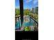 Balcony view overlooking a sparkling community pool with palm trees and lounge chairs, perfect for relaxation at 145 Pier View St # 316, Charleston, SC 29492
