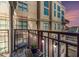 Cozy balcony featuring string lights, outdoor seating, and city views during a colorful sunset at 150 Bee St # 714, Charleston, SC 29401