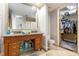 Bathroom with a glass bowl sink, granite countertop, and a view of a spacious walk-in closet at 150 Bee St # 714, Charleston, SC 29401