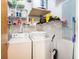 Functional laundry room with a washer, dryer, storage shelves, and all essential supplies at 150 Bee St # 714, Charleston, SC 29401
