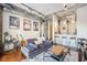 Bright living room with exposed ductwork, neutral sofa, modern decor, and breakfast bar at 150 Bee St # 714, Charleston, SC 29401