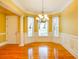 Elegant dining room with hardwood floors, natural lighting, and wainscotting at 1717 Rivertowne Country Club Dr, Mount Pleasant, SC 29466
