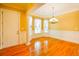 Bright dining room with hardwood floors, elegant lighting, and large windows with decorative trim at 1717 Rivertowne Country Club Dr, Mount Pleasant, SC 29466