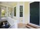 Exterior entryway with wooden porch, complemented by white trim, and black front door at 1717 Rivertowne Country Club Dr, Mount Pleasant, SC 29466