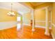 Bright living room with hardwood floors, featuring columns and open access to the kitchen area at 1717 Rivertowne Country Club Dr, Mount Pleasant, SC 29466