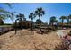 Swings and mature landscaping offer a serene spot in this inviting community playground at 1717 Rivertowne Country Club Dr, Mount Pleasant, SC 29466