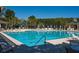 Large community pool with chairs and umbrellas, perfect for a relaxing day outdoors at 1717 Rivertowne Country Club Dr, Mount Pleasant, SC 29466