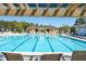 Stunning pool view through a pergola, featuring ample seating and lush green surroundings at 1717 Rivertowne Country Club Dr, Mount Pleasant, SC 29466