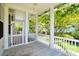 Relaxing screened-in porch with white railings and wooden flooring, perfect for outdoor enjoyment at 1717 Rivertowne Country Club Dr, Mount Pleasant, SC 29466