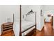 Bedroom boasts a decorative four poster bed, hardwood floors, and ample natural light at 221 Church St, Mount Pleasant, SC 29464