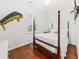 Bedroom features a four poster bed, hardwood floors, and shuttered windows at 221 Church St, Mount Pleasant, SC 29464