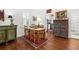 Charming dining room with hardwood floors, vintage decor, and views into kitchen at 221 Church St, Mount Pleasant, SC 29464
