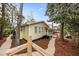 Charming yellow home featuring a red roof, with mature trees and gravel pathways at 221 Church St, Mount Pleasant, SC 29464