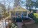 Charming cottage-style home featuring a screened porch and beautifully landscaped yard with brick walkway at 221 Church St, Mount Pleasant, SC 29464