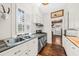 Galley kitchen with stainless appliances, wood countertops and lots of natural light at 221 Church St, Mount Pleasant, SC 29464