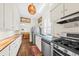 Galley kitchen features stainless steel appliances, wood countertops and opens to the dining area at 221 Church St, Mount Pleasant, SC 29464