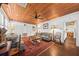 Spacious living room with hardwood floors, wood-paneled ceiling, and ample natural light at 221 Church St, Mount Pleasant, SC 29464