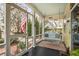 Relaxing screened porch with a comfortable hanging swing and view of the front yard at 221 Church St, Mount Pleasant, SC 29464