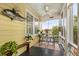 Cozy screened porch featuring a ceiling fan, table and chairs for dining or relaxing at 221 Church St, Mount Pleasant, SC 29464